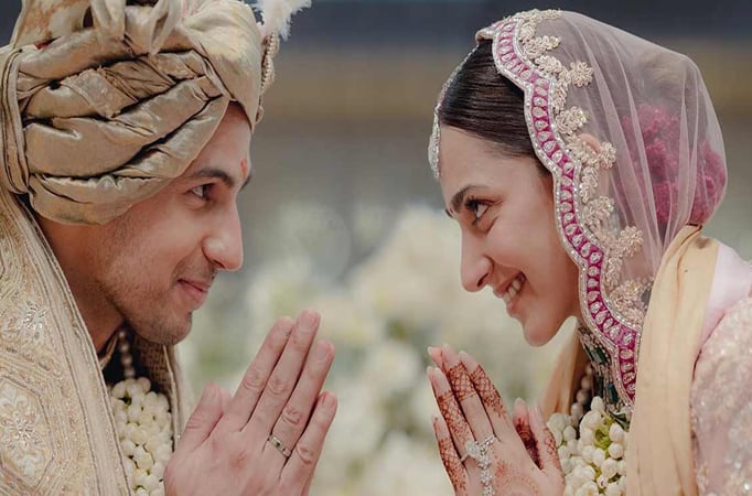 Newlyweds Sidharth Malhotra and Kiara Advani complement each other in red outfits as they leave Delhi airport hand-in-hand