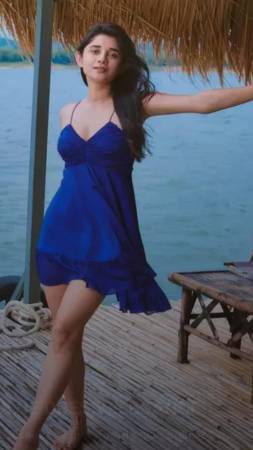In fluttery blue dress